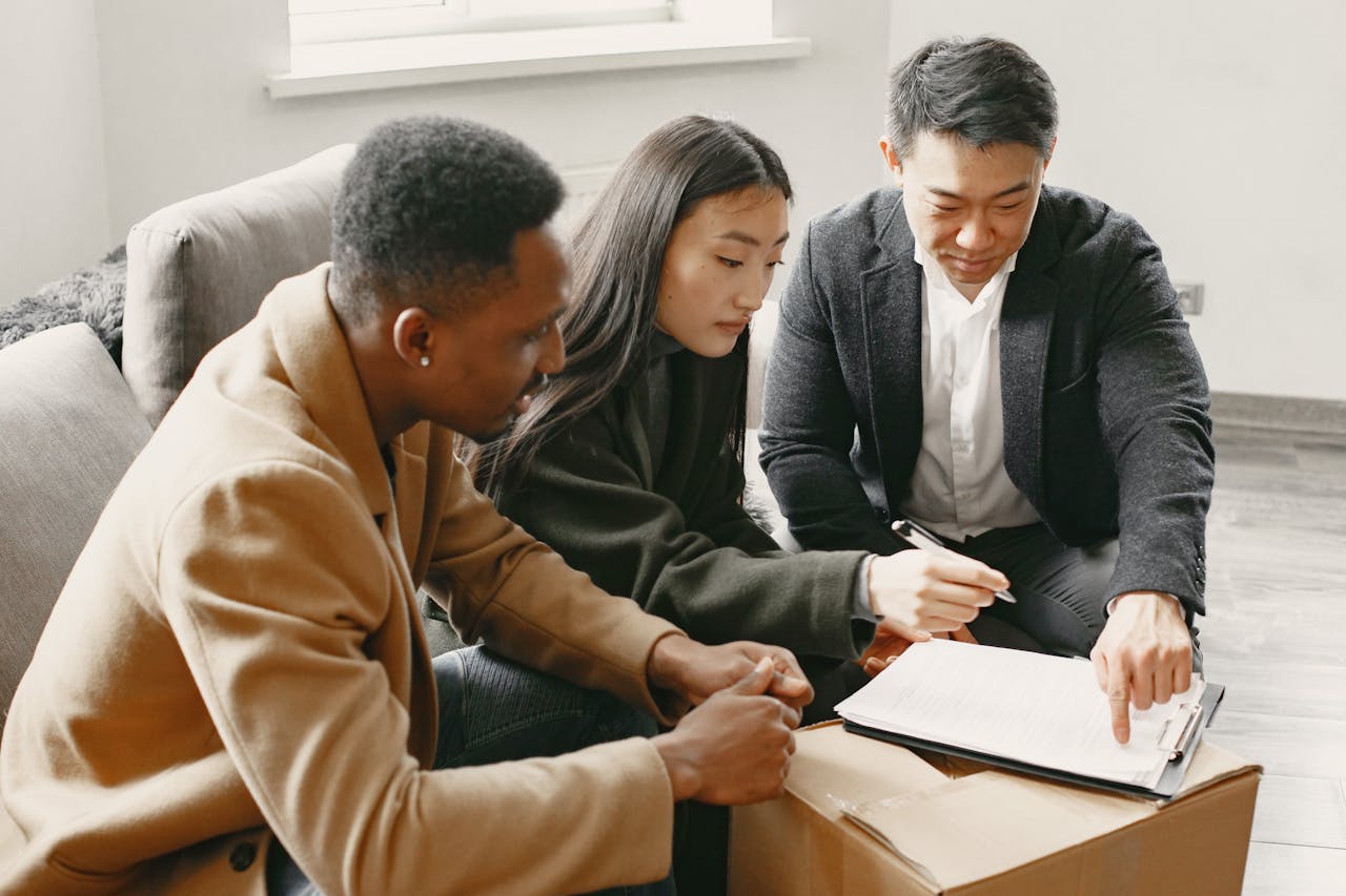 services-03 Group of professionals working together indoors, focusing on paperwork and collaboration.